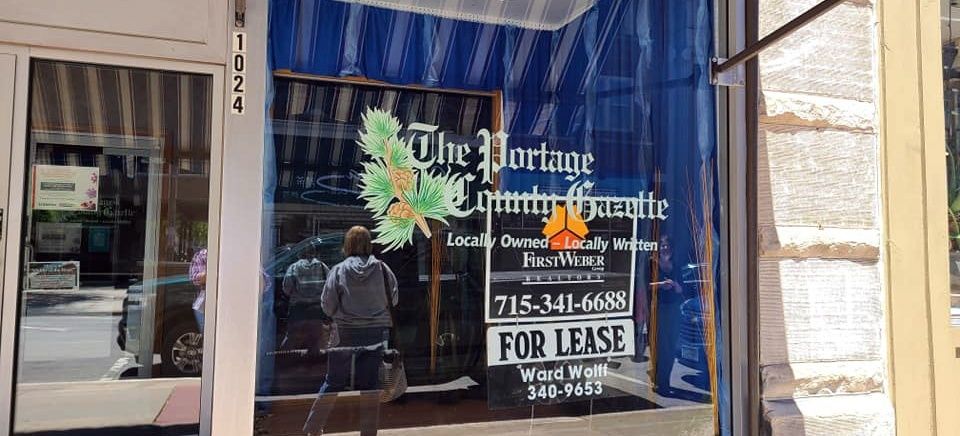 Closed newspaper storefront displaying a